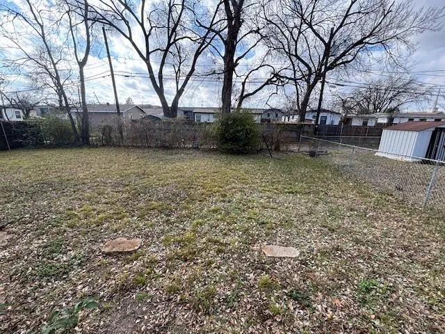 a view of backyard with large trees
