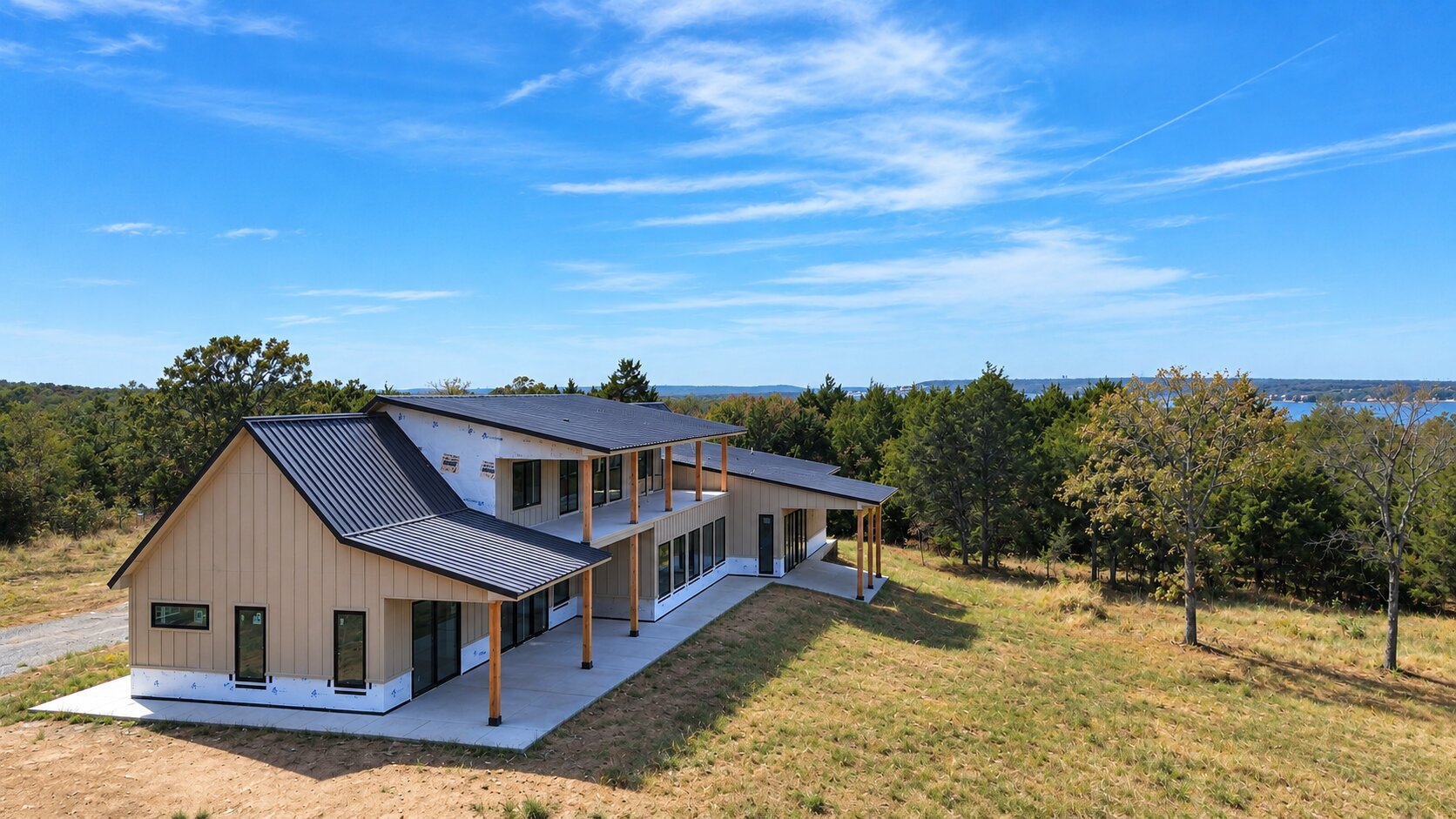 62 Dixie Ridge Eufaula, OK 74432 - Photo 5 of 9 Contemporary exterior featuring a metal roof, board and batten siding, multiple covered patios, and an upper-level balcony