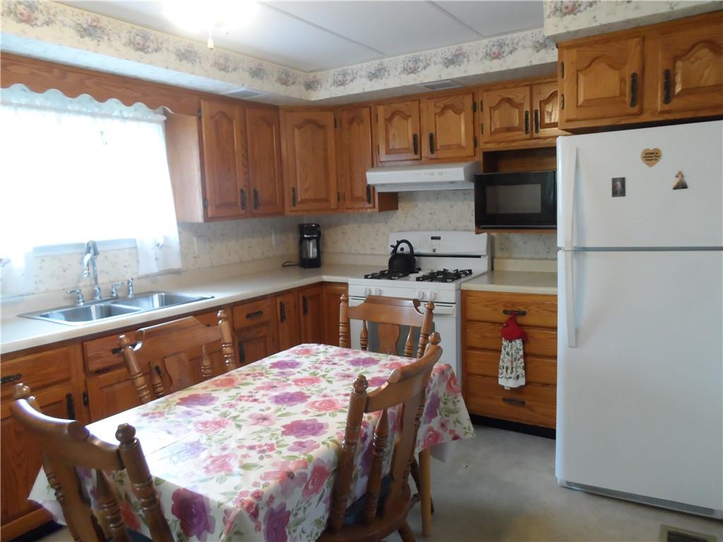130 Harrison Avenue Butler, PA 16001 - Photo 3 of 24 a kitchen with a sink a stove and a refrigerator