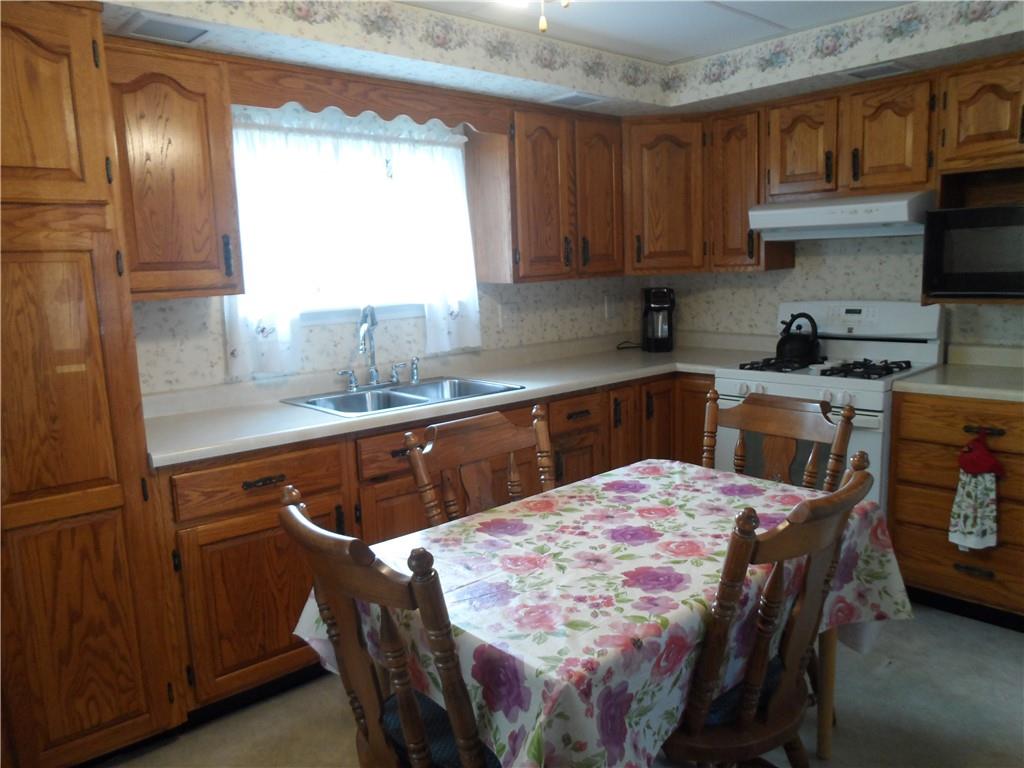 130 Harrison Avenue Butler, PA 16001 - Photo 4 of 24 a kitchen with stainless steel appliances sink microwave and cabinets