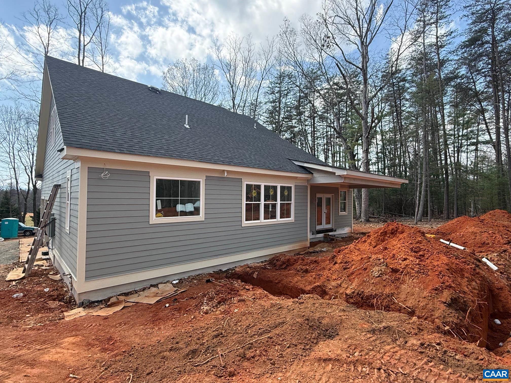 4360 Garth Road Crozet, VA 22932 - Photo 7 of 52 a backyard of a house with large trees and outdoor seating