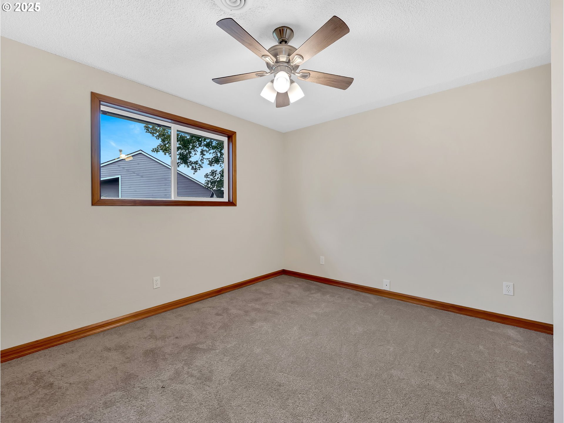821 Southwest 14th Street Troutdale, OR 97060 - Photo 21 of 27 an empty room with a chandelier fan and windows