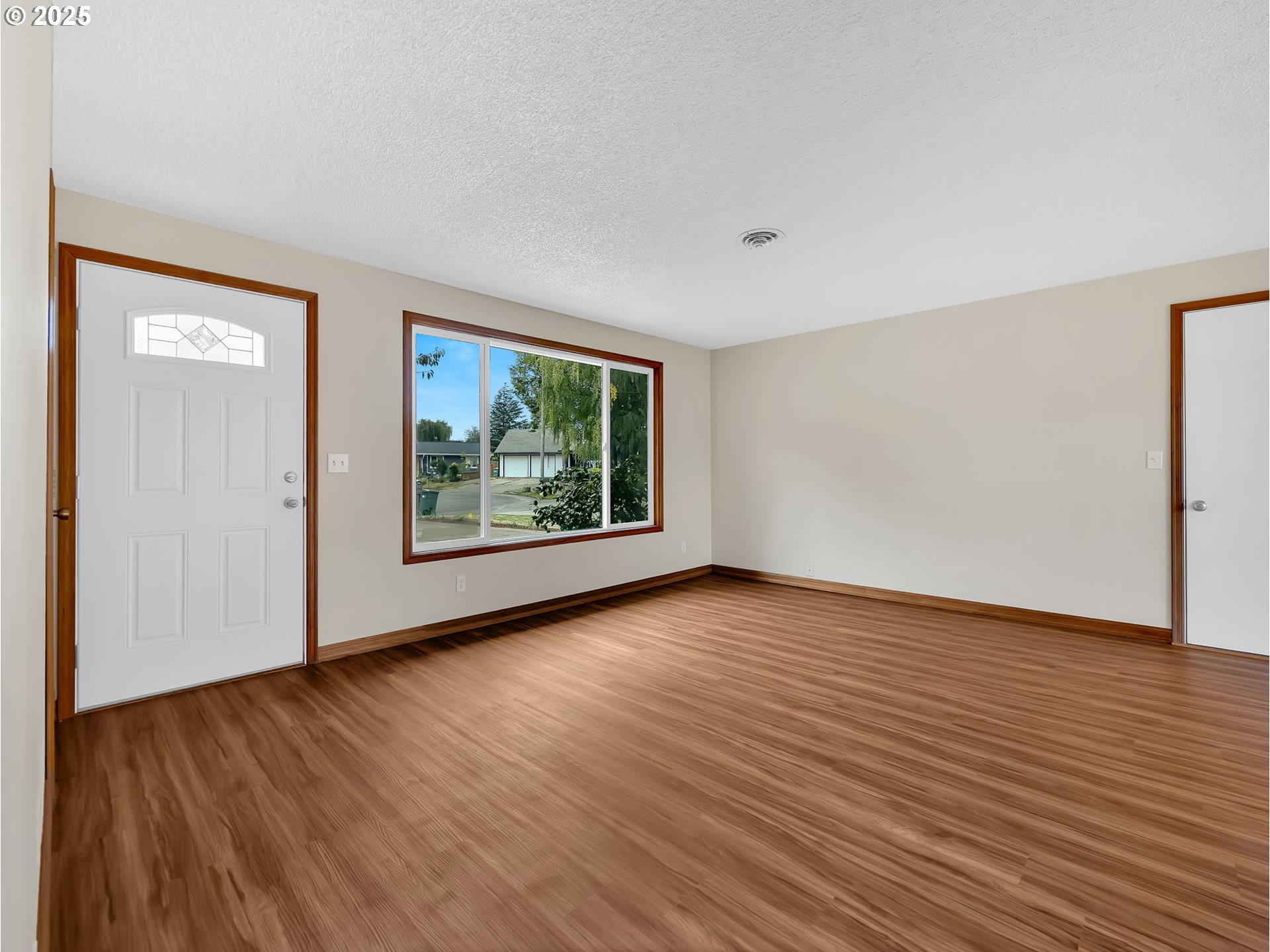 821 Southwest 14th Street Troutdale, OR 97060 - Photo 6 of 27 a view of an empty room with wooden floor and a window