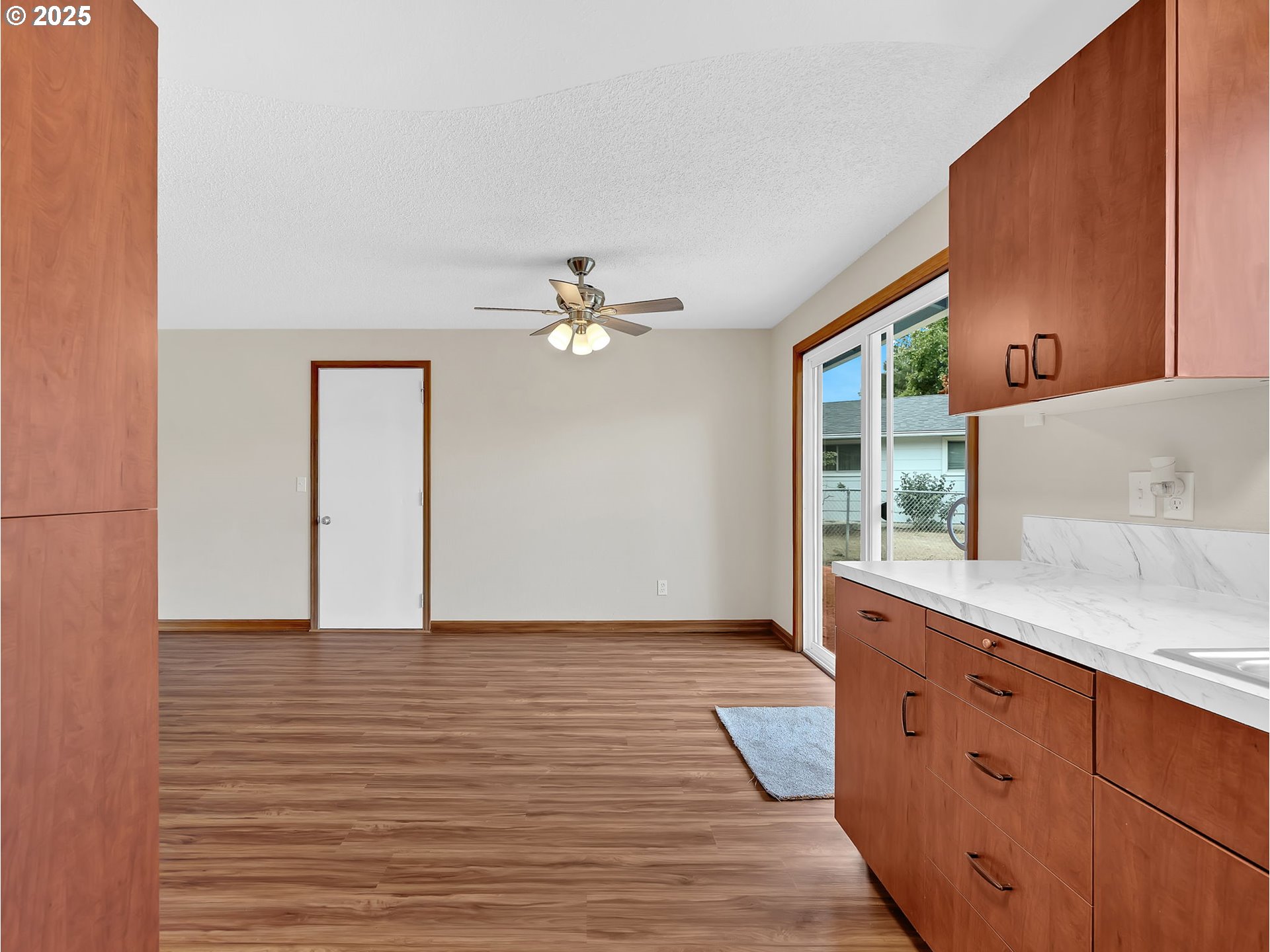821 Southwest 14th Street Troutdale, OR 97060 - Photo 10 of 27 a view of an empty room with window and wooden floor