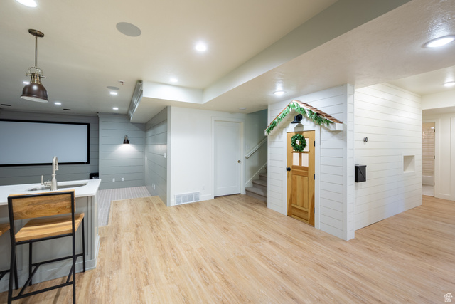 630 East Center Street Alpine, UT 84004 - Photo 61 of 115 Open-concept recreational space featuring wood-finish flooring, recessed lighting, and an integrated wet bar with a white countertop and stainless steel sink