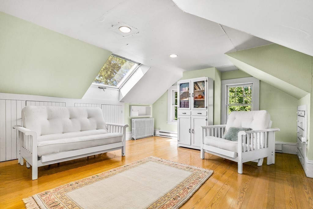 216 Spring Street Marshfield, MA 02050 - Photo 25 of 36 a living room with furniture and a rug