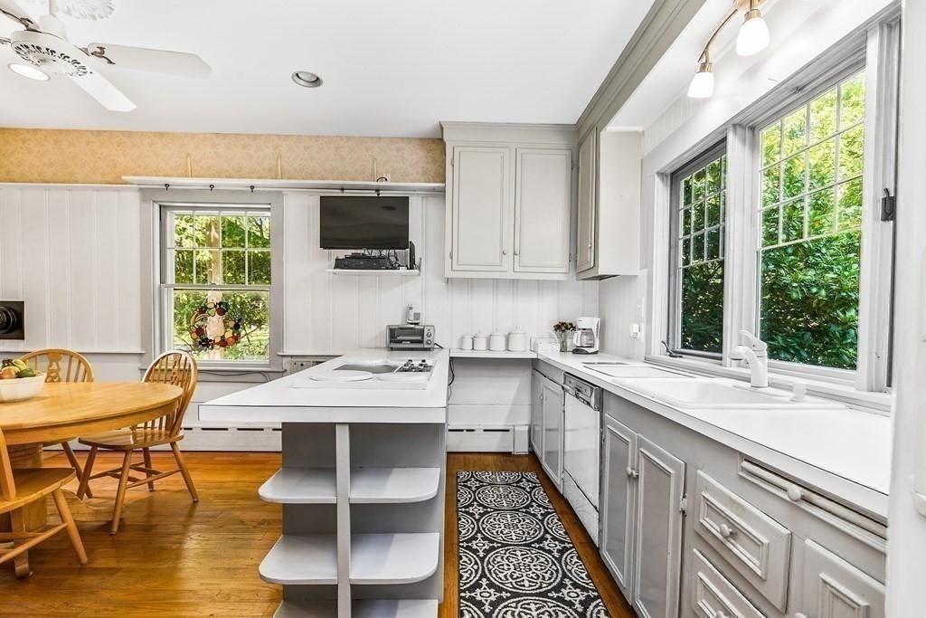 216 Spring Street Marshfield, MA 02050 - Photo 10 of 36 a kitchen with stainless steel appliances kitchen island granite countertop a sink and cabinets