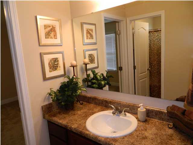 4611 Hermosa Road Crestview, FL 32539 - Photo 15 of 19 a bathroom with a granite countertop sink a mirror and a shower