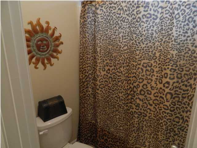 4611 Hermosa Road Crestview, FL 32539 - Photo 16 of 19 a bathroom with a toilet and a shower curtain