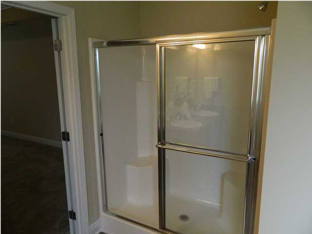 4611 Hermosa Road Crestview, FL 32539 - Photo 8 of 19 a bathroom with a glass shower door