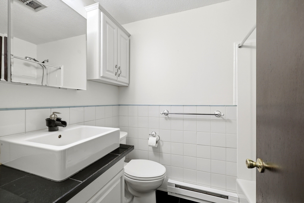 80 Damon Road, Unit 2303 Northampton, MA 01060 - Photo 14 of 23 a white toilet sitting next to a bathroom sink