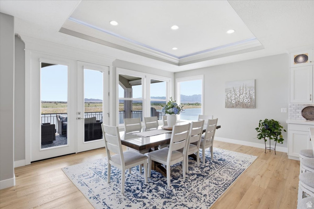 21 Pier Place Tooele, UT 84074 - Photo 13 of 112 Recessed lighting and a tray ceiling illuminate this dining area featuring light wood-finish flooring