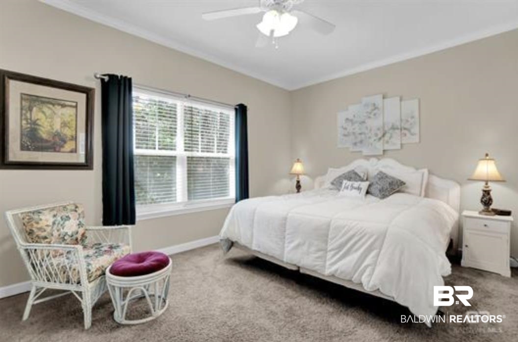 430 West Fort Morgan Road Gulf Shores, AL 36542 - Photo 16 of 27 Carpeted room featuring a white ceiling fan, crown molding, and neutral wall tones