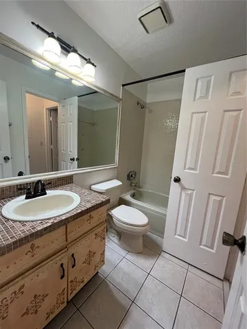 a bathroom with a double vanity sink toilet and shower