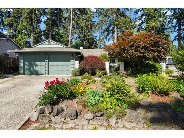 a front view of a house with a yard and fountain