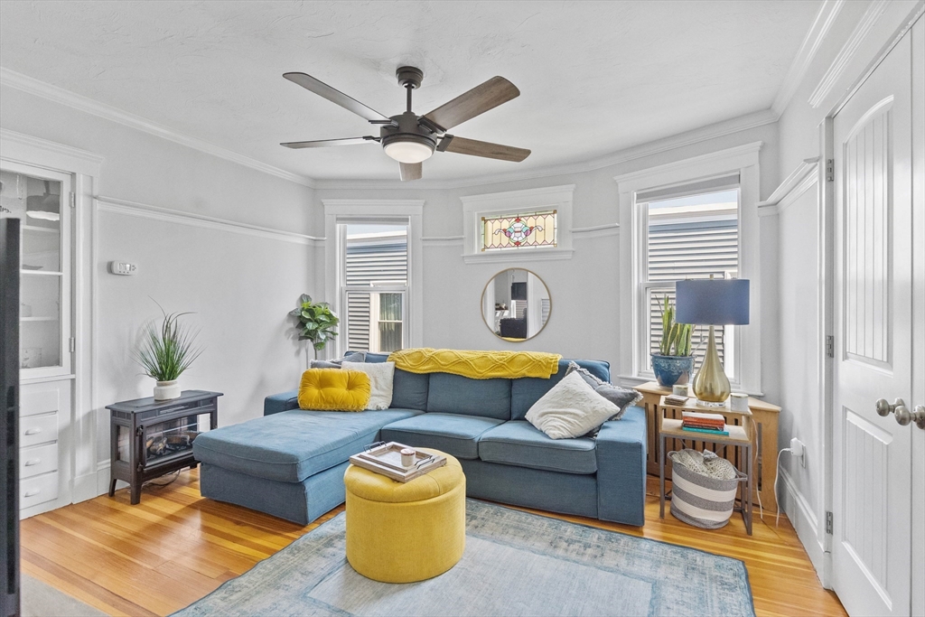108 King Street, Unit THREE Boston, MA 02122 - Photo 3 of 18 a living room with furniture and a large window
