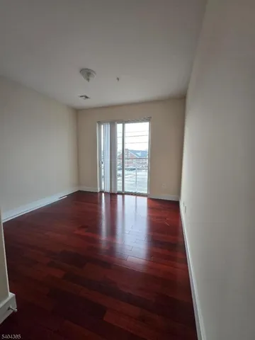 a view of wooden floor and windows in a room