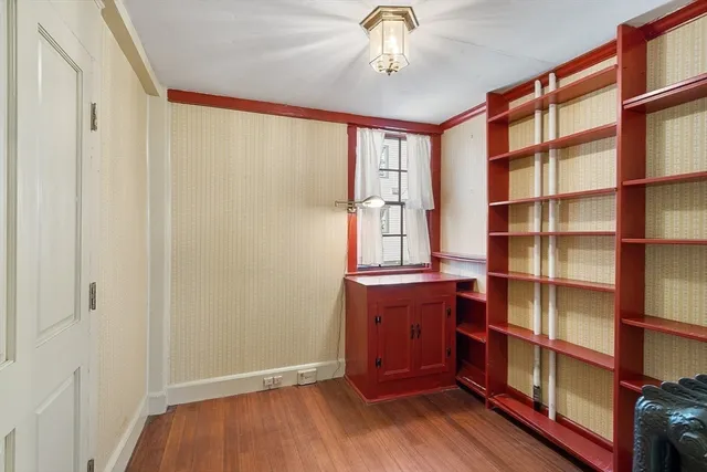 a view of room with window and wooden floor