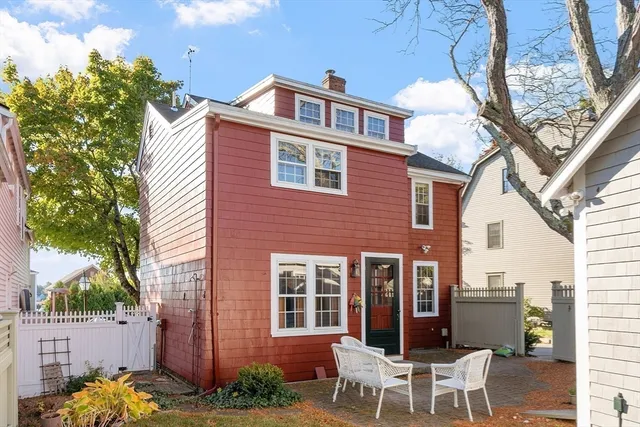 a view of a house with backyard porch and sitting area