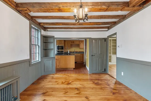 a view of kitchen and hall with wooden floor