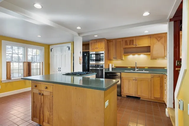 a large kitchen with granite countertop a large window and a sink