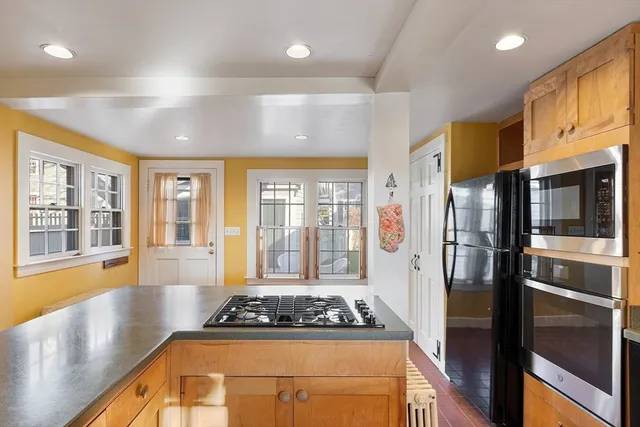 a kitchen with a refrigerator and a stove