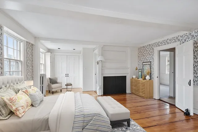 a spacious bedroom with a bed and a fireplace