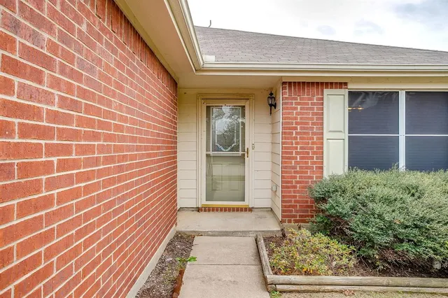 a view of a brick house with a large window
