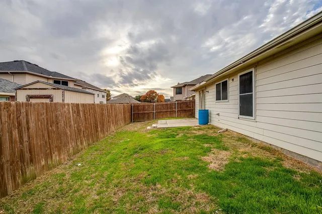 a view of a backyard with a garden and deck