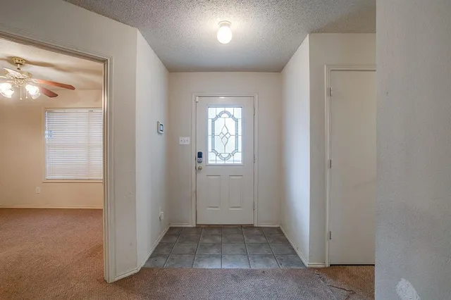 an empty room that has a mirror in it