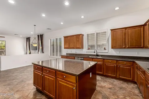 a view of kitchen with stainless steel appliances granite countertop a stove and a sink with granite countertops