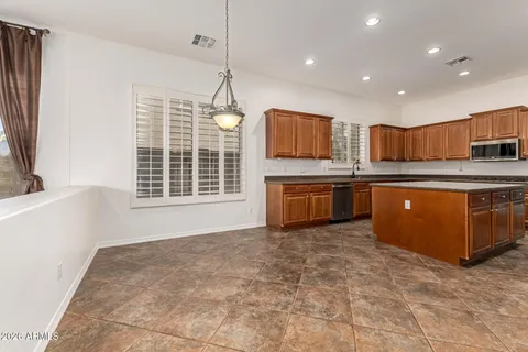 a view of a room with chandelier fan and windows
