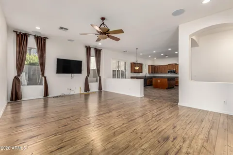 a view of a living room and kitchen with hardwood floor