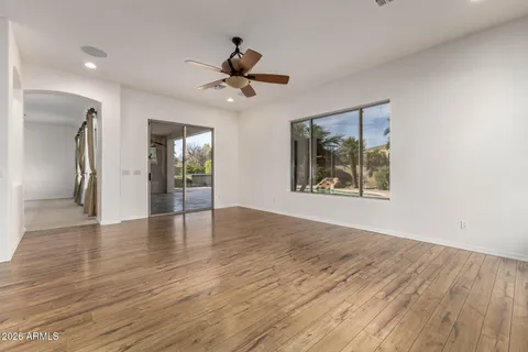 a view of a livingroom with a ceiling fan and window