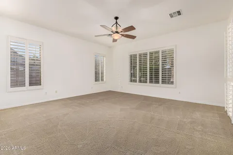 a view of a livingroom with a ceiling fan and window