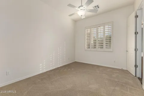 a view of empty room with window and bathroom