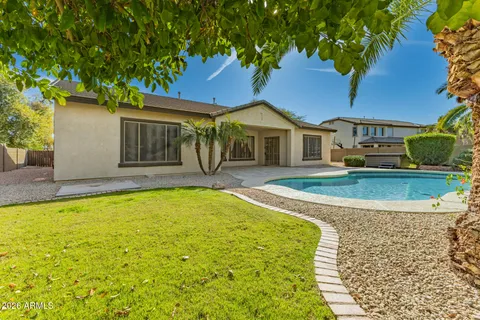 a view of a swimming pool and a yard