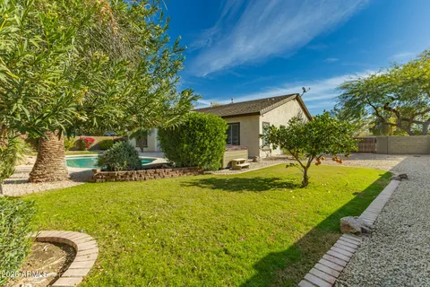 a white house with a yard and sitting area