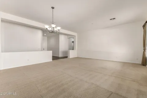 a view of a chandelier in big room and chandelier