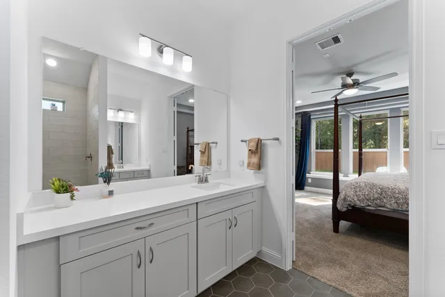 a en suite bathroom with double sink and a mirror