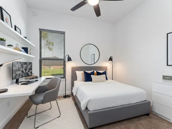 a bedroom with a bed a chair and a chandelier