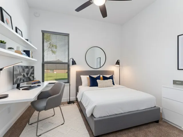 a bedroom with a bed a chair and a chandelier