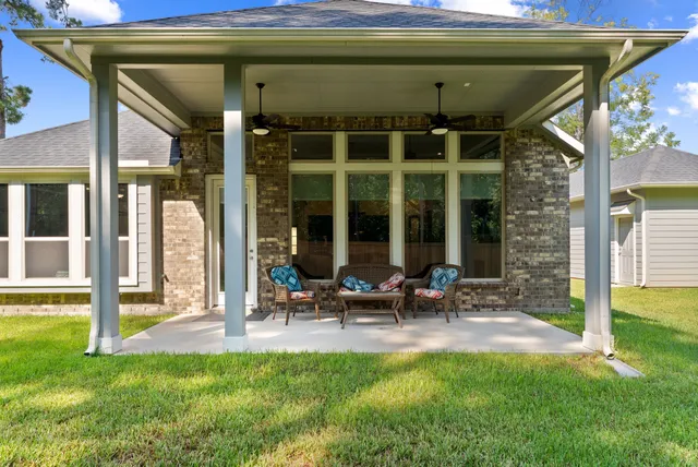 a group of people sitting in front of a house