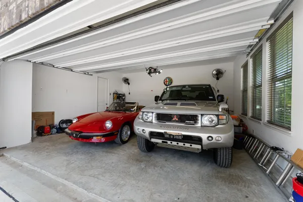 a view of a hallway with furniture and a window