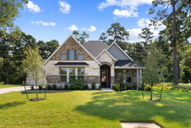 a front view of a house with swimming pool yard and green space