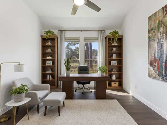 a living room with furniture a lamp and a potted plant