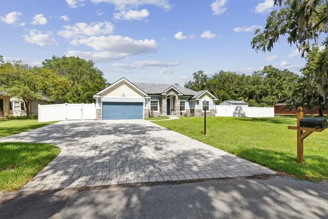 a view of a hallway with wooden floor and a dining room