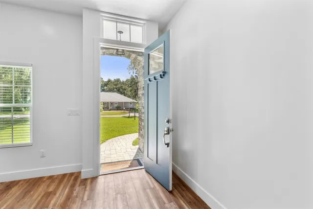 a dining room with furniture window and wooden floor