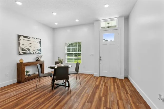 a view of a dining room with furniture and wooden floor