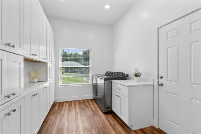 a view of an empty room with closet and wooden floor